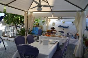a woman sitting at a table under a white tent at B&B Gi & Giò in Càbras