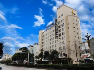 a white building with a sign on the side of it at James Joyce Coffetel Guangyuan High-Speed Railway Station Dongba Municipal Government in Guangyuan