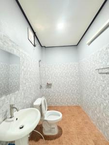 un baño con inodoro y lavabo en เกาะลิบงKohlibong forest house, en Trang 24 fotos más