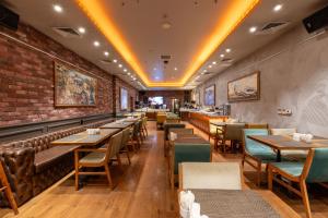 a restaurant with tables and chairs and a brick wall at Pera Tulip Hotel & Spa in Istanbul