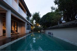 a swimming pool in front of a building at ANALO Resort Hotel in Lijiang