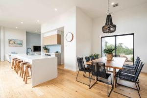 a kitchen and dining room with a table and chairs at Ocean Vista Escape Jan Juc in Bellbrae