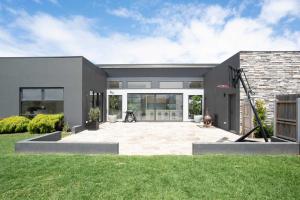 a house with a large patio in the yard at Ocean Vista Escape Jan Juc in Bellbrae
