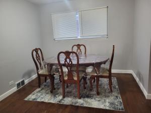 a dining room table with four chairs and a window at Townhome Near Northwestern and Hospital in Evanston +25 photos