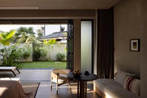 a living room with a couch and a table at ANALO Resort Hotel in Lijiang