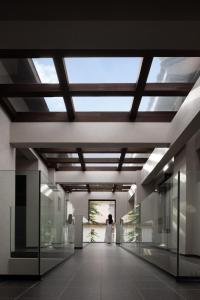 a bride and groom in a building with a skylight at ANALO Resort Hotel in Lijiang +105 photos