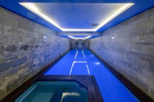 a swimming pool in a building with blue lighting at Pera Tulip Hotel & SPA in Istanbul