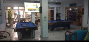 a room with two pool tables and a tv at Hotel Coosonav Cartagena in Cartagena de Indias