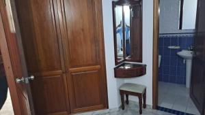 a bathroom with a wooden door and a sink at Hotel Coosonav Cartagena in Cartagena de Indias