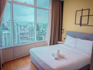 a hotel room with a bed and a large window at vortex Suites KLCC KL in Kuala Lumpur +62 photos