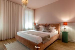 a bedroom with a large bed and a large window at MISTRO House & Courtyard - by Sleep in MURANO in Murano +5 photos