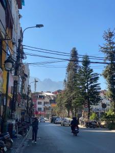 a person riding a motorcycle down a city street at SaPa Global Hotel in Sapa