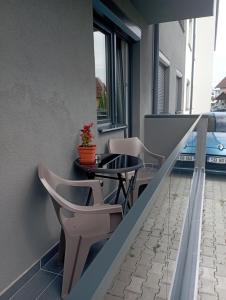 a balcony with a table and chairs on a building at Pitters Home Șelimbăr-Sibiu in Şelimbăr