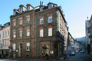 an old brick building on the corner of a street at Strumpfeck Suites in Traben-Trarbach