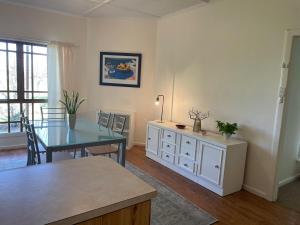a living room with a table and a dining room at The Vale Farmhouse Rural Setting in Farrell Flat +11 photos