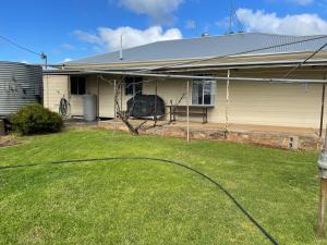 a house with a yard with a hose at The Vale Farmhouse Rural Setting in Farrell Flat