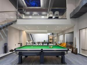 a billiard room with a pool table in it at GYA Hotel Taiyuan Jinyang Street Grand Shanxi Hospital in Taiyuan