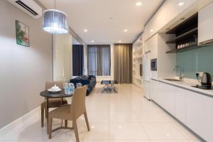 a kitchen and living room with a table and a couch at The Platinum Kuala Lumpur by MAHA in Kuala Lumpur