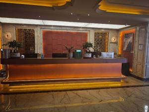 a lobby with a bar in a building at JTOUR Inn Wuhan Textile University in Wuhan