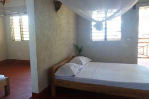 Postel nebo postele na pokoji v ubytování Ylang hôtel