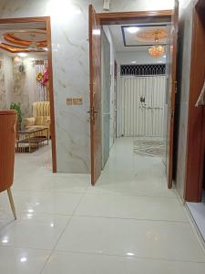 a hallway with a door leading to a living room at AL Imran VILLA in Lahore +1 photo