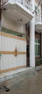 a white fence on the side of a building at AL Imran VILLA in Lahore