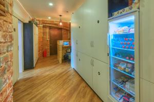 a hallway with a refrigerator filled with lots of food at Boxtel Hostel in Moscow