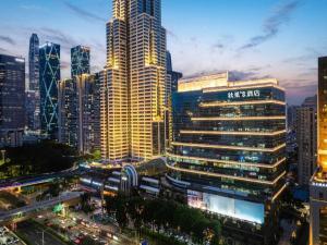 a city skyline with tall skyscrapers at night at Grand Holiday Hotel in Shenzhen