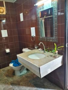 een badkamer met een wastafel en een toilet bij Kata Lina rooftop in Kata Beach