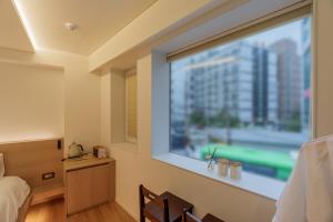 a bedroom with a large window with a view at 이루다스테이 호텔 고척돔점 in Seoul