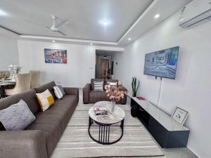 a living room with a couch and a table at Mombasa Nyali opp Baobab Resort in Mombasa