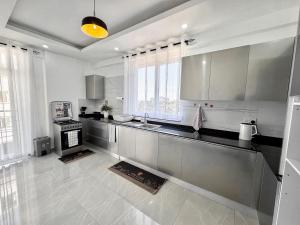 a large white kitchen with a stove in it at Mombasa Nyali opp Baobab Resort in Mombasa
