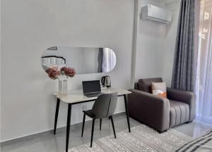 a room with a desk with a laptop and a chair at Mombasa Nyali opp Baobab Resort in Mombasa +1 photo