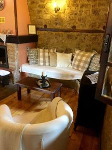 a living room with two couches and a table at Varosi Guesthouse in Edessa