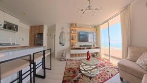 a kitchen and living room with a view of the ocean at Ocean Blue, Vista Frontal Al Mar in Lima