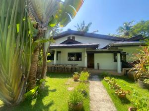 a house with a garden in front of it at Sabai Resort in Ao Nang Beach