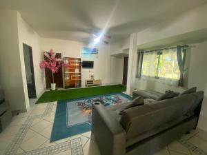 a living room with a couch and a television at Sabai Resort in Ao Nang Beach