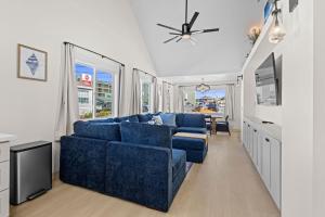 a living room with a blue couch and a tv at Seaside Getaway B in Seaside