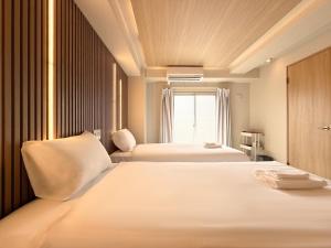 a bedroom with two beds and a window at Osaka Ebisu Hotel in Osaka +60 photos