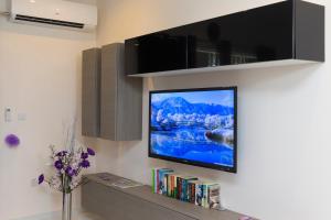 a flat screen tv on a wall in a living room at Marsascala 2 Bedroom Apartment close to Beach! in Marsaskala