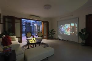 a living room with a couch and a large screen at 500m2 Private Villa 2 min to West Lake 7BR in Hanoi