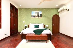 a bedroom with a bed and a green wall at 500m2 Private Villa 2 min to West Lake 7BR in Hanoi