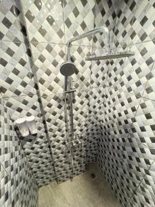 a shower in a bathroom with a tiled wall at Brady's Ubud Villas in Ubud +5 photos