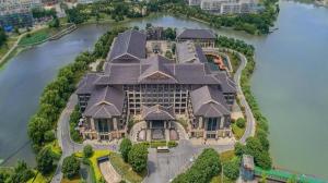 a large house on an island in the water at Tong Que Tai Jinling Hotel Tongling Anhui in Tongling
