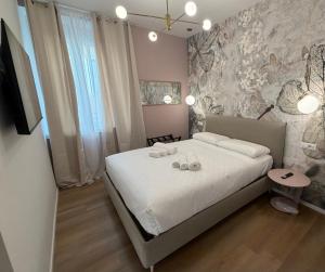 a bedroom with a bed with two towels on it at Maison Rasella Palace Suites in Rome