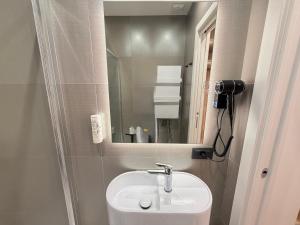 a bathroom with a sink and a mirror at Maison Rasella Palace Suites in Rome +126 photos