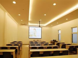 uma sala de conferências com cadeiras e um ecrã de projecção em Jinjiang Inn Yantai Penglaige Zhonglou North Road em Penglai