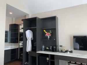 a kitchen with a white dress hanging on a shelf at Sangtawan Resort in Ko Chang