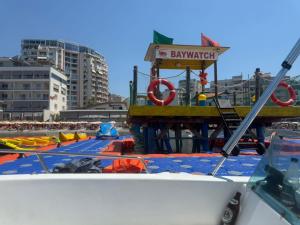 a view of a beach with a life guard station at Aragosta Hotel in Durrës