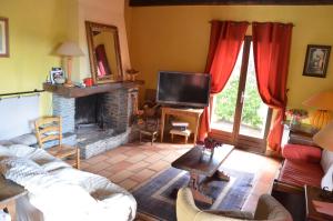 a living room with a couch and a fireplace at CASA-CORSA chambre d'hote in Cervione